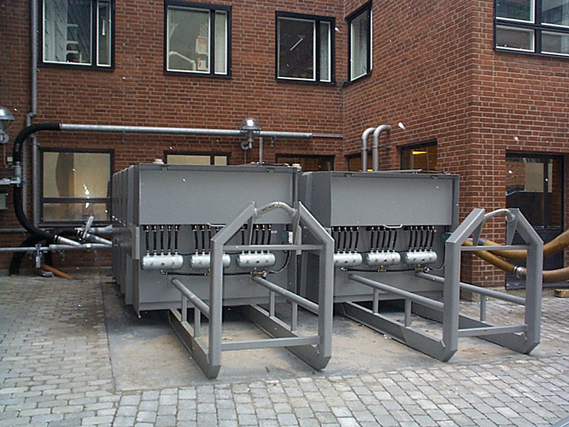 Two gray BEAL mobile filter separator units installed on a brick-paved industrial site, designed for hook lift transport and efficient handling of large dust volumes and various material types.